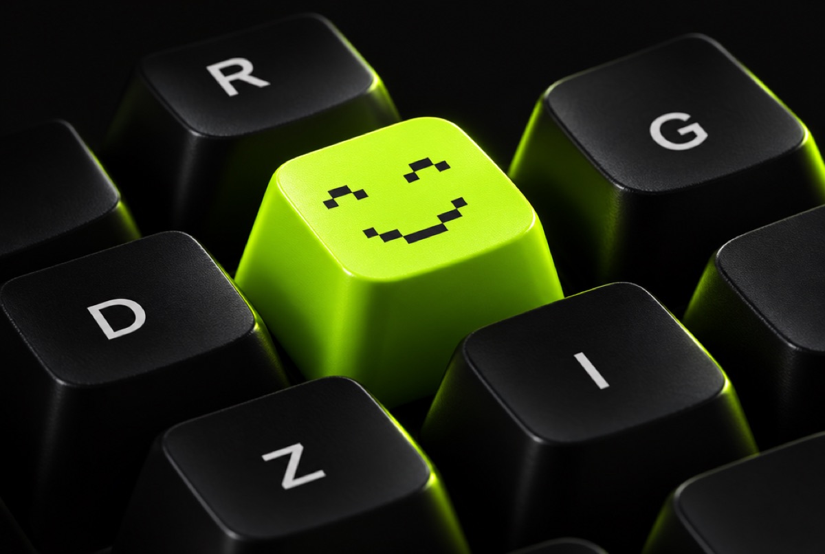Lime keycap with a pixel smile among black Z I L O keys